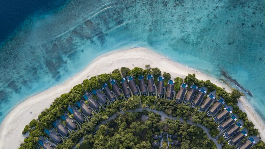 Aerial view of the beach and island villas at Furaveri Maldives